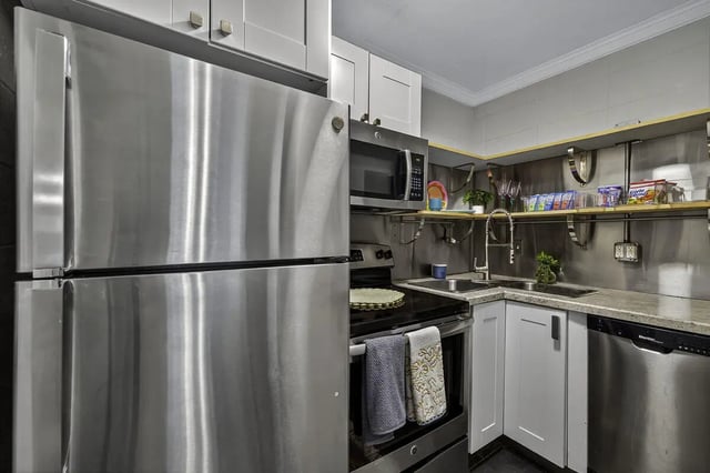 Stainless steel refrigerator microwave stove sink kitchen at 759 Basin LLC in Tallahassee Student Accommodation