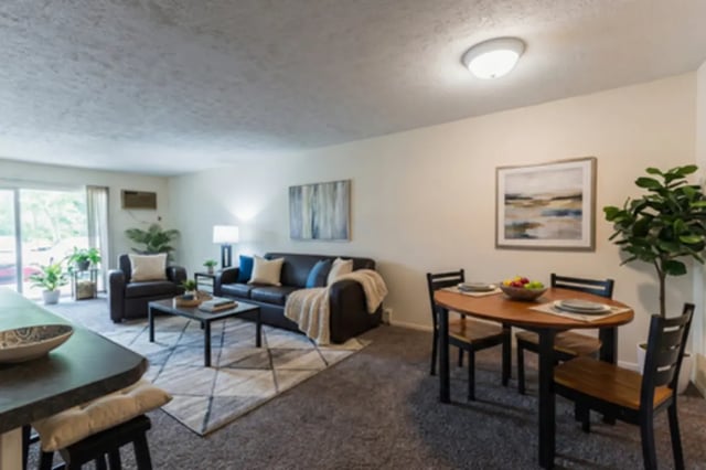 Living area with sofa and dining table living room at Waters Edge Apartments in East Lansing Student Accommodation