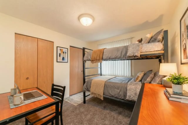 Bunk beds desk with laptop and closet bedroom at Waters Edge Apartments in East Lansing Student Accommodation