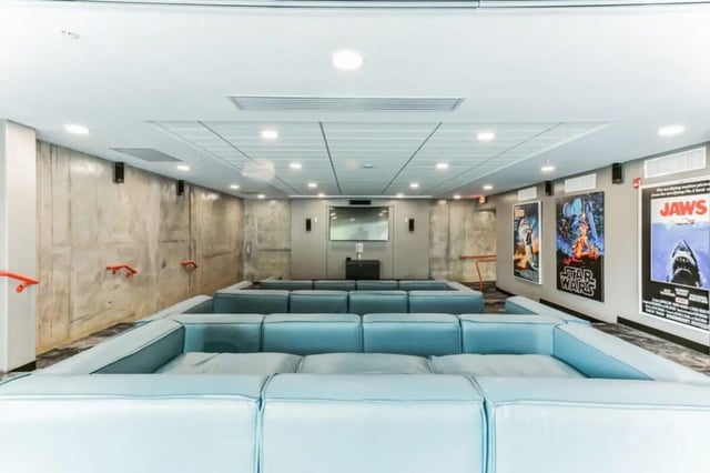 Modular seating with movie posters playing area at Current Midtown Apartments in Williamsburg Student Accommodation