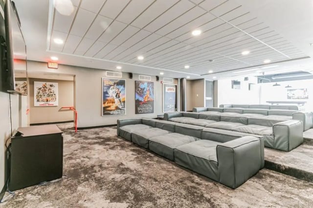 Tiered seating with movie posters cinema room at Current Midtown Apartments in Williamsburg Student Accommodation