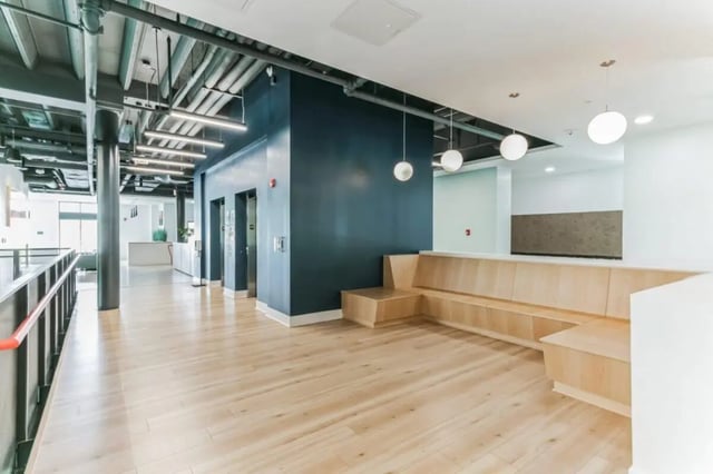 Elevator bank and bench seating common area at Current Midtown Apartments in Williamsburg Student Accommodation