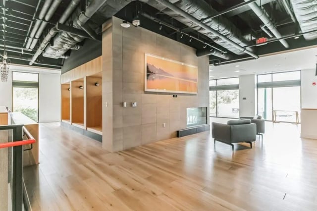 Recessed seating area with modern fireplace living room at Current Midtown Apartments in Williamsburg Student Accommodation