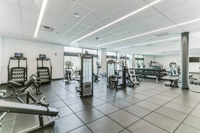 Gym equipment including weights and machines Fitness room at Current Midtown Apartments in Williamsburg Student Accommodation