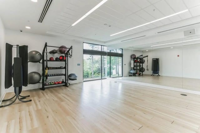 Gym with exercise balls and weights fitness area at Current Midtown Apartments in Williamsburg Student Accommodation