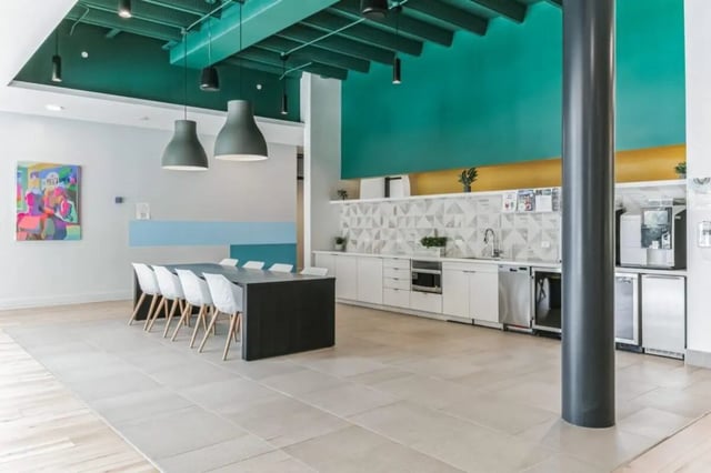 Modern kitchen area with dining table and white chairs kitchen Image at Current Midtown Apartments in Williamsburg Student Accommodation