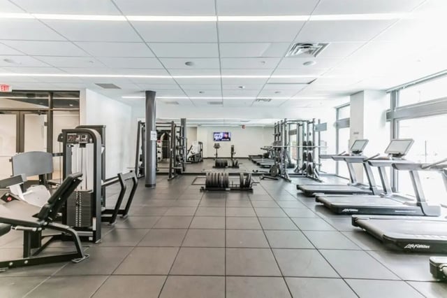Gym equipment treadmills weight machines and racks Gym at Current Midtown Apartments in Williamsburg Student Accommodation