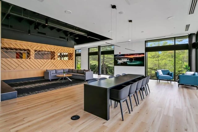 Modern lounge with sofas dining table and chairs living room at Current Midtown Apartments in Williamsburg Student Accommodation