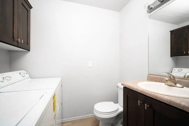 Washer dryer toilet sink vanity bathroom at 7th & University Apartments in St. George Student Accommodation