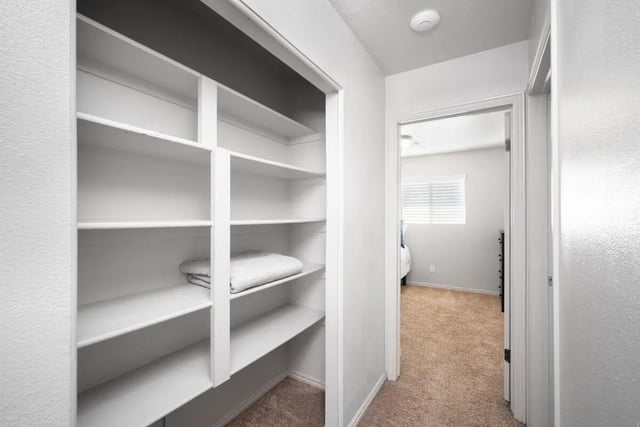 White shelving with folded towels bedroom view at 7th & University Apartments in St. George Student Accommodation