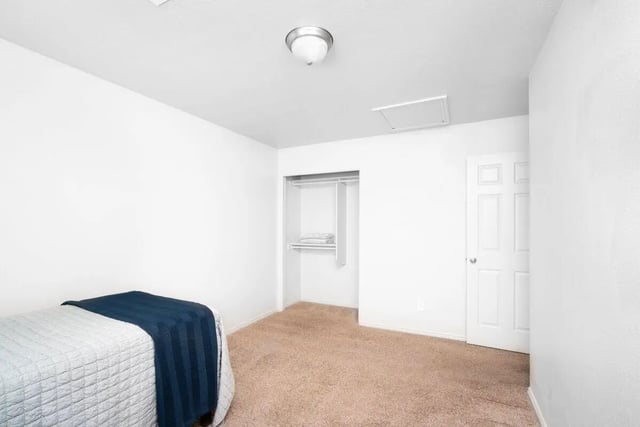 Bed closet and door bedroom at 7th & University Apartments in St. George Student Accommodation