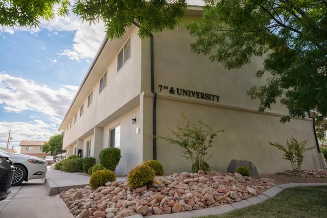 Cream building with 7th & University sign exterior at 7th & University Apartments in St. George Student Accommodation