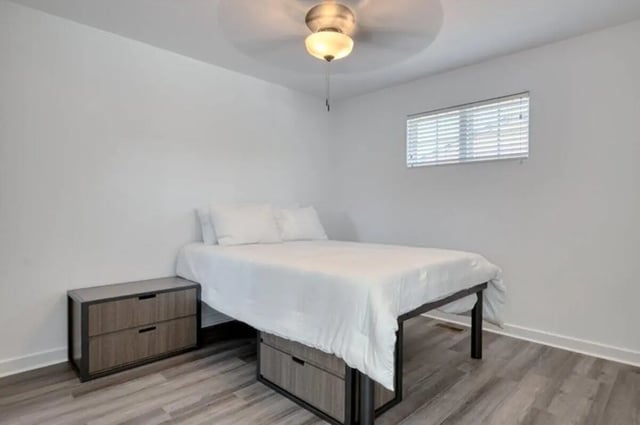 Bed with white linens bedside drawers ceiling fan bedroom at Haven Blacksburg in Blacksburg Student Accommodation