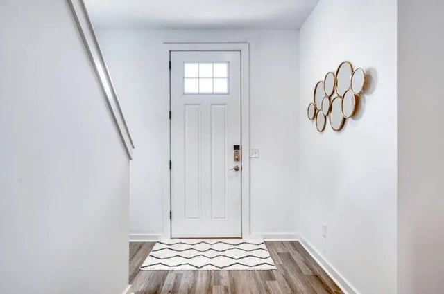 White door patterned rug gold mirrors entryway at Haven Blacksburg in Blacksburg Student Accommodation