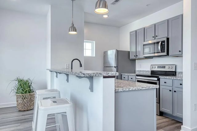Counter with stools and appliances kitchen at Haven Blacksburg in Blacksburg Student Accommodation