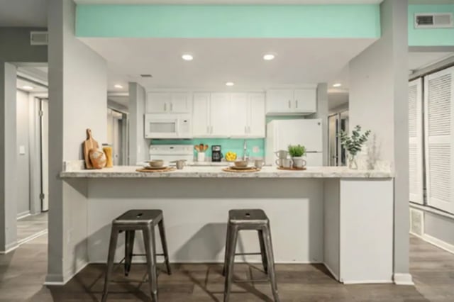Two stools counter with bowls and kitchen at Campus Hill Apartments