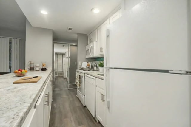 White cabinets refrigerator stove and countertop kitchen at Campus Hill Apartments
