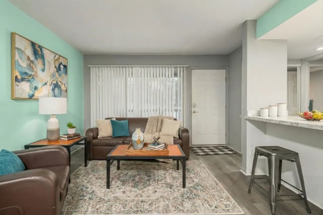 Brown leather couches coffee table rug living room at Campus Hill Apartments