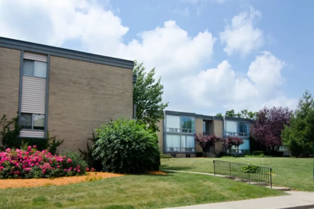 Brick apartment buildings with large windows exterior at East Knolls Apartment in East Lansing Student Accommodation