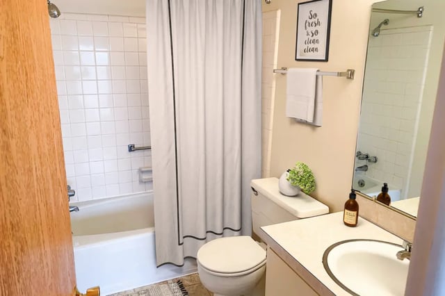 Shower tub toilet sink with decor bathroom at East Knolls Apartment in East Lansing Student Accommodation