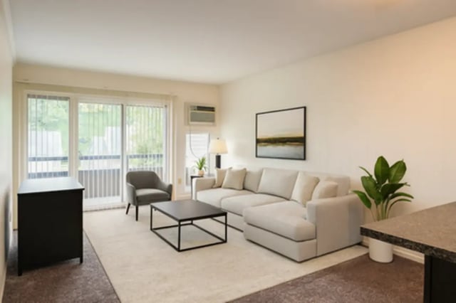 Sectional sofa coffee table armchair accent cabinet living room at Americana Apartments in East Lansing Student Accommodation