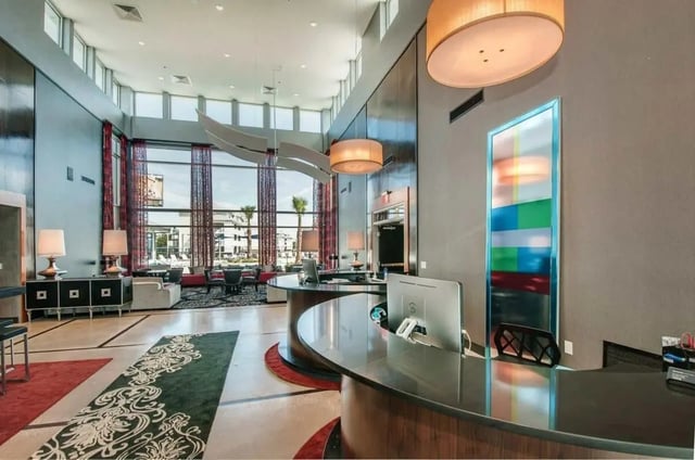 Reception desk with computers and seating area Lobby at The Ave at Norman Apartments in Norman Student Accommodation