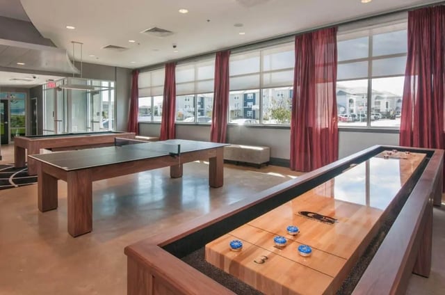 Shuffleboard ping pong and pool tables common area at The Ave at Norman Apartments in Norman Student Accommodation