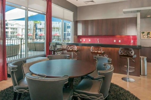 Round table plush chairs bar area communal space at The Ave at Norman Apartments in Norman Student Accommodation