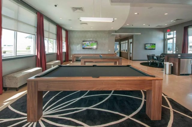Billiard and ping pong tables with TV living room at The Ave at Norman Apartments in Norman Student Accommodation