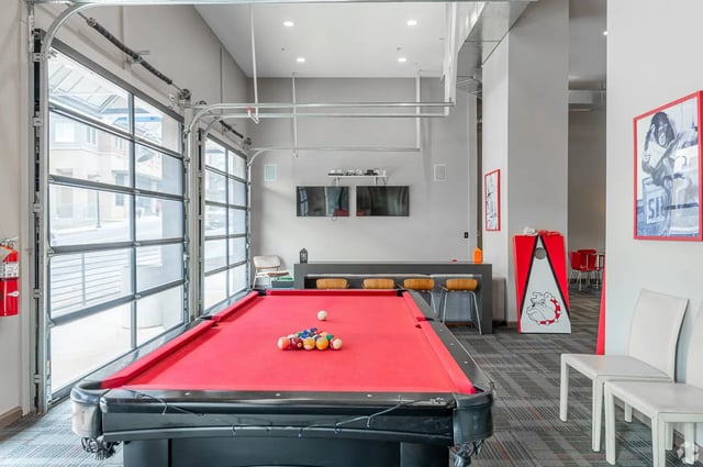 Pool table with balls bar chairs and TVs recreation area at Eclipse on Broad in Athens Student Accommodation