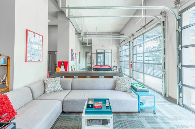 Gray sectional sofa pool table art living room at Eclipse on Broad in Athens Student Accommodation