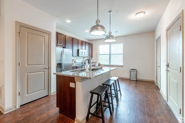 Kitchen island with bar stools and appliances kitchen at Eclipse on Broad in Athens Student Accommodation