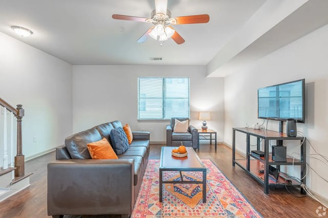Leather couch coffee table rug TV living room at Eclipse on Broad in Athens Student Accommodation