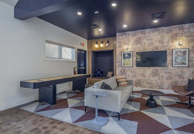 Shuffleboard couch television and seating area at The Roost in Rexburg Student Accommodation