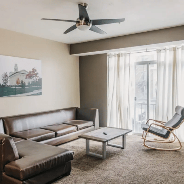 Brown sectional sofa coffee table rocking chair living room at Cedars Women's Housing in Rexburg Student Accommodation