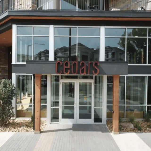 Cedars entrance with glass doors and windows exterior at Cedars Women's Housing in Rexburg Student Accommodation