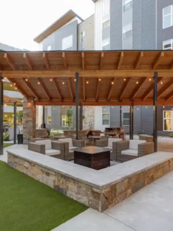 Covered outdoor seating area with fire pit exterior at Cedars Women's Housing in Rexburg Student Accommodation