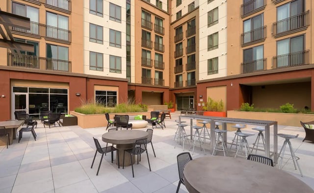 Outdoor seating area with tables and chairs exterior at Stonefire Berkeley in Berkeley Student Accommodation