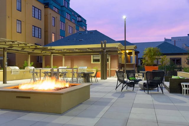 Fire pit grills chairs and tables outdoor lounge area at Stonefire Berkeley in Berkeley Student Accommodation