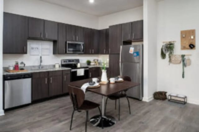 Dark cabinets stainless steel appliances table kitchen at Anthem House in Gainesville Student Accommodation