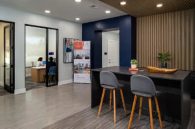 Modern lounge area with dark table two chairs lounge at Anthem House in Gainesville Student Accommodation