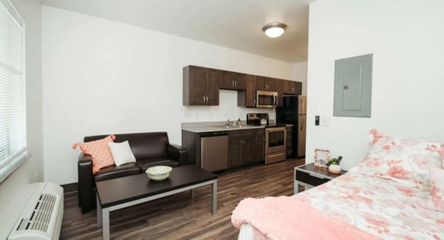Sofa bed kitchen appliances wood floor living room at WestEdge in Springfield Student Accommodation