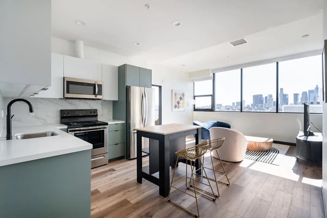 Kitchen dining area with city view living room at Atlas House Apartments in Los Angeles Student Accommodation