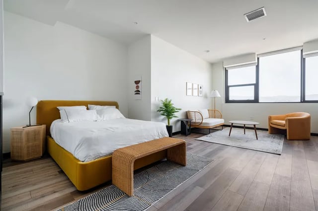 Yellow bed rattan bench living room with sofa bedroom at Atlas House Apartments in Los Angeles Student Accommodation