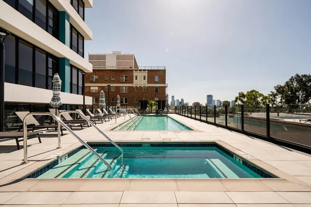Jacuzzi pool lounge chairs and city view swimming area at Atlas House Apartments in Los Angeles Student Accommodation
