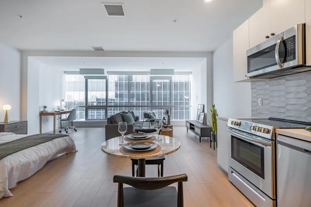 Studio apartment with bed desk sofa kitchen living area at Atlas House Apartments in Los Angeles Student Accommodation