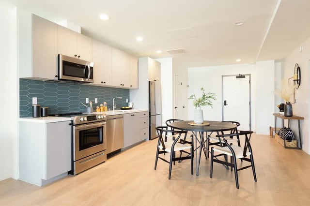 Kitchen with dining table and chairs kitchen at Atlas House Apartments in Los Angeles Student Accommodation