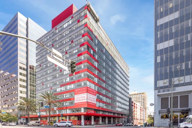 Modern red and grey building with street view exterior at Atlas House Apartments in Los Angeles Student Accommodation