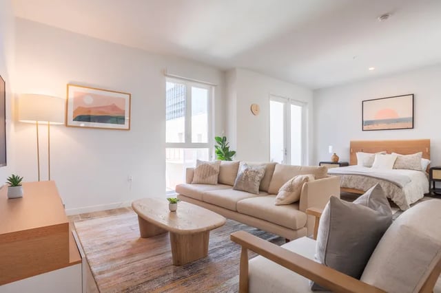 Sofa bed coffee table and art living room at Atlas House Apartments in Los Angeles Student Accommodation