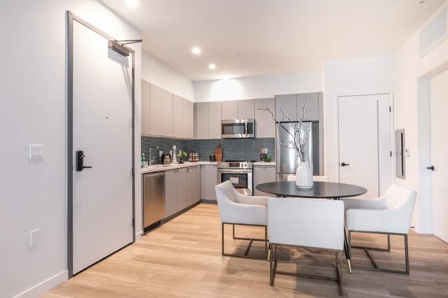 Kitchen with table chairs and modern appliances kitchen at Atlas House Apartments in Los Angeles Student Accommodation